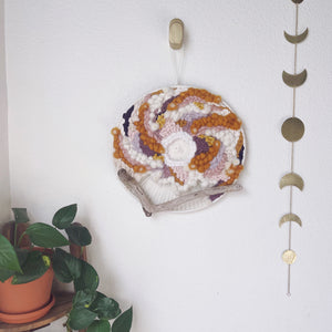 round woven wall hanging, purple, gold, cream, rose, driftwood